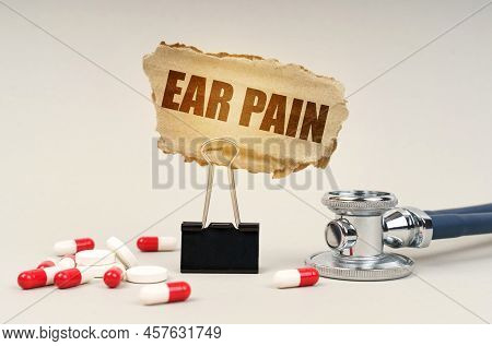 Medical Concept. Near The Stethoscope Are Pills And A Clip With A Cardboard Sign - Ear Pain