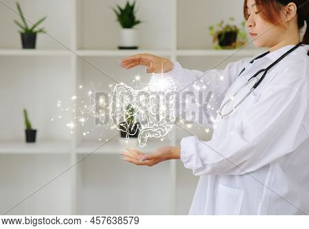 Doctor Holding A Virtual Intestine. Human Organ Drawn By Hand, Healthcare Hospital Service Concept, 