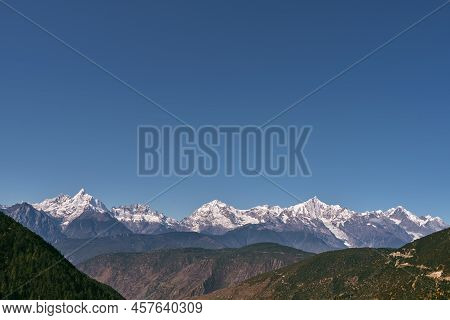 Snow Capped Meili Mountain Range Under Blue Sky In China's Sichuan Province