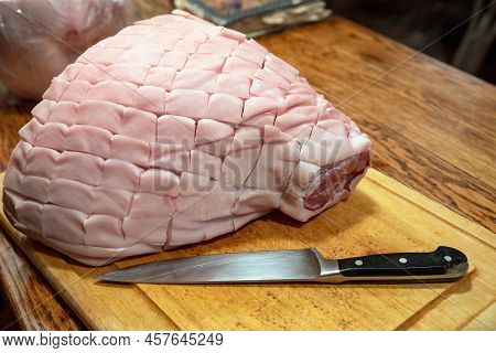 Antique Wooden Table With Wood Grain Texture And Cutting Board With Black-handled Chefs Knife And A 