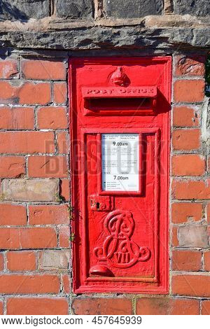 Prestatyn, Uk. Jun 22, 2022. A Red Postbox Mounted In A Brick Wall