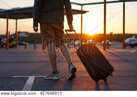 Young Man Traveler Walking With Carrying Hold Suitcase In The Airport. Passenger Travel On Weekend. 