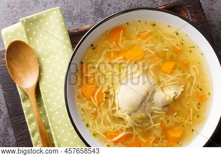 Dietary Chicken Soup With Vermicelli And Vegetables Close-up In A Bowl On A Wooden Tray On The Table
