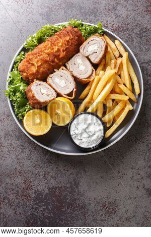 Karageorge Schnitzel Serbian Stuffed Cutlet Served With French Fries And Tartar Sauce Close-up In A 