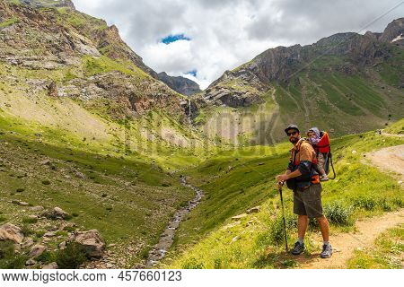 A Young Man Next To The Salto De Tendenera Waterfall In The Ripera Valley, Panticosa, Pyrenees