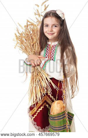 Bulgarian Woman  Or Young Girl In Traditional Folklore Dress Holds In Hands Golden Wheat And Freshly