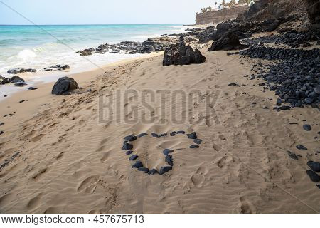 On A Beach A Heart Was Formed From Individual Stones. Stone Heart On The Beach.