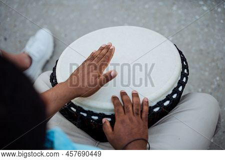 The Guys Hands Play The Drum, The African Beats The Rhythms Of The Music On The Djemba, The Ethnic M