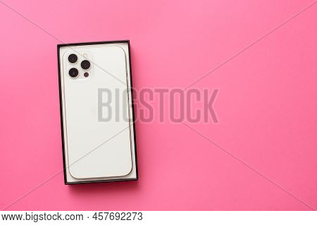 Stariy Oskol, Russia - July 5, 2021: New White Iphone On Pink Paper Background
