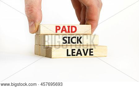 Paid Sick Leave Symbol. Concept Words Paid Sick Leave On Wooden Blocks. Doctor Hand. Beautiful White