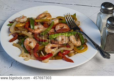 Sauteed Shrimp Served With Sauteed Onons And Peppers,