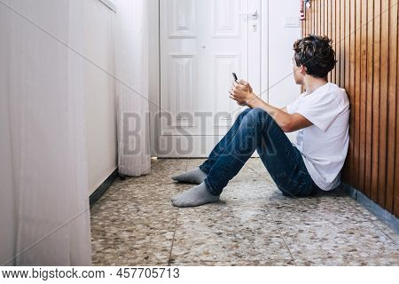 People Inside Home For Stayhome Lockdown Emergency Coronavirus - Young Man Sit Down On The. Floor Wi