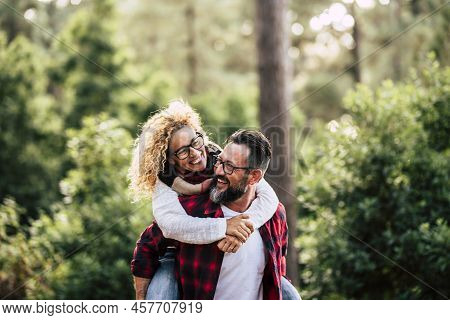 Happiness And Cheerful People Concpet With Joyful Couple Playing And Having Fun Together In The Wood