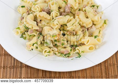 Prepared Short Curved Ruffled Pasta, So-called Creste Di Galli Or Rooster Comb, Mixed With Stewed Mi