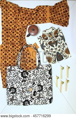 Flat Lay Batik Clotes With Canting, Small Pan And Wax Earthenware Glass Isolated On White Background