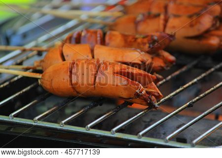 Grilled Sausage Or Sosis Panggang On Grill In The Street Food. Selective Focus