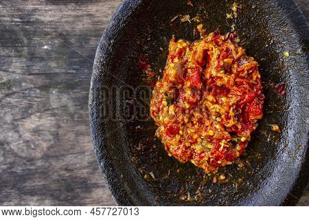 Fresh Sambal Served On Stone Mortar (cobek). Sambal Is Traditional Sauce From Indonesia Made From Ch