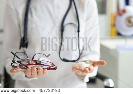 Doctor Hands Hold Choice Of Glasses And Contact Lenses. Vision Correction Ophthalmology And Excellen