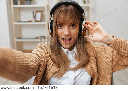 Excited Young Blonde Student Lady Freelancer In Warm Sweater In Headphones Listen Fav Songs Sitting 