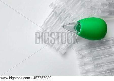 Single Dose Ampoules Of Sterile Isotonic Sea Water Solution And Nasal Aspirator On White Background,