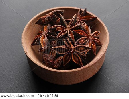 Aromatic Anise Stars In Wooden Bowl On Grey Background