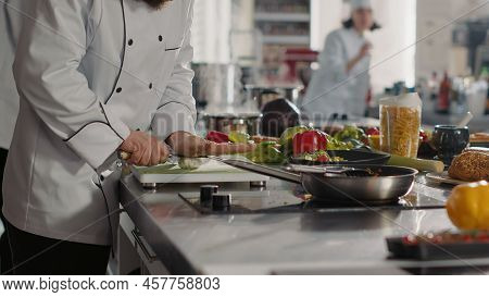 Male Cook Preparing Garlic To Add To Aromatic Food Recipe, Making Delicious Meal With Fresh Ingredie