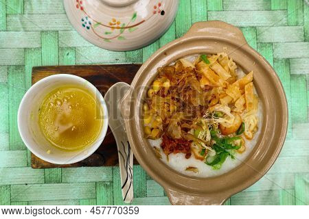 Porridge Served On Hot Claypot Topped With Chicken, Sweet Corn, Skipjack Tuna, Tofu, Green Onions, C