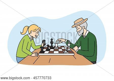 Mature Grandfather Playing Chess With Small Girl. Happy Elderly Man Enjoy Board Game With Little Chi