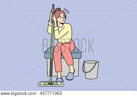 Unhappy Housewife Sitting With Mop After Cleaning Feel Distressed With Home Work. Upset Woman Housek