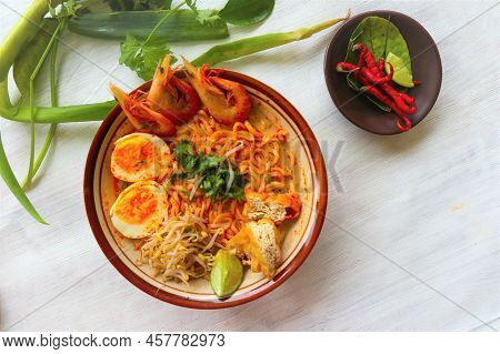 Laksa, Laksa Curry Made From Vermicelli, Noodles, Bean Sprouts, Egg, Tofu Lime, And Shrimp With A Sp