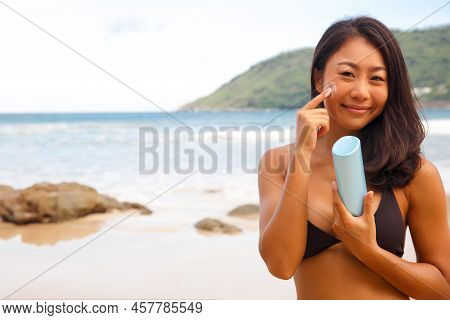 Closeup Woman Applying Sunblock Cream Lotion On Beach For Broad Spectrum Uva, Uvb Sun Protection