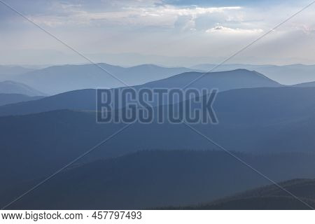 Panoranic Blue View Of Mountain Hills And Meadows During Sunset In Carpathians, Chornohora, Ukraine