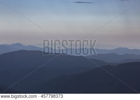 Panoranic Blue View Of Mountain Hills And Meadows During Sunset In Carpathians, Chornohora, Ukraine