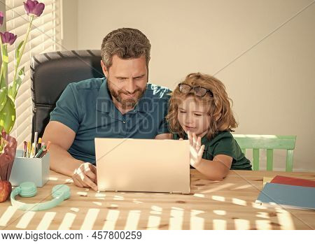 Homeschooling And Estudy. Back To School. Father And Son Use Computer At Home.