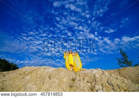 Ukrainian Patriot Girl In A Yellow Dress Against A Blue Sky. Summer Photo. Blue Sky. Sunny Day. Free