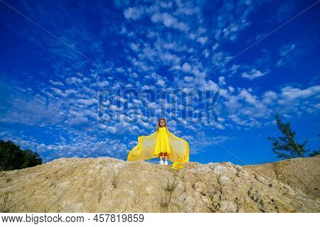 Ukrainian Patriot Girl In A Yellow Dress Against A Blue Sky. Summer Photo. Blue Sky. Sunny Day. Free