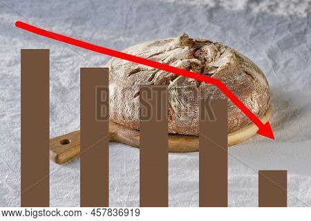 Crisis Graph With Negative Statistics. Background With Loaf Of Dark Bread On Wood With Linen Towel.