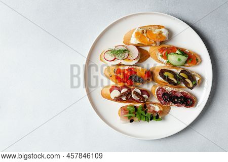 Brushetta, Antipasti  Or Authentic Traditional Spanish Tapas Set On White Plate. Variety Of  Pinchos