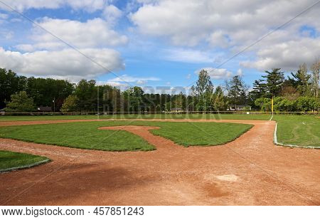 A Wide Angle Shot Of An Unoccupied Baseball Field On A Cloudy Day.