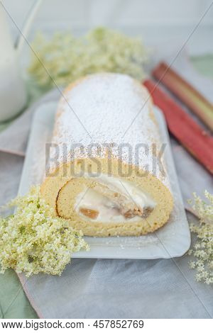 Sweet Home Made Bisuit Roll With Rhubarb And Elderflower On A Table