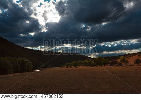 Landscape With Dramatic Sky Over The Hills . Dark Clouds Scenery