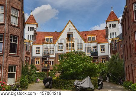 Amsterdam, Netherlands. June 2022. View Of Characteristic Brick Residential Building In The Style Of