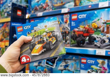 Lego Constructor In A Customer's Hand. A Customer Takes A Box Of Lego From A Shelf In A Store. Minsk