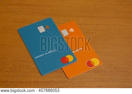 Minas Gerais, Brazil - July 09, 2022: Green And Orange Credit Cards With Mastercard Brand