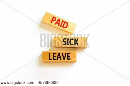 Paid Sick Leave Symbol. Concept Words Paid Sick Leave On Wooden Blocks. Beautiful White Table White 