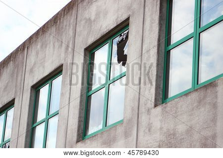 Broken Glass In Window With Green Frame At  Factory