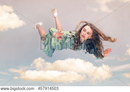 Beautiful Girl Levitating In Mid-air, Falling Down And Her Hair Messed Up Soaring From Wind, Model F