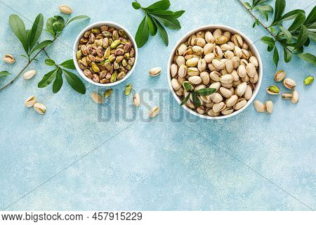 Pistachios. Whole Pistachios With Green Leaves And Pistachio Nut Kernels. Healthy Natural Vegetarian