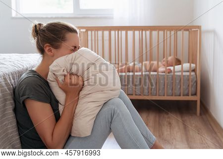 Depressed Mother Screaming With Desperation In Pillow To Overcome Negative Emotions