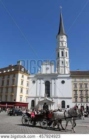 Vienna, Austria - 25 April 2012: Saint Michael's Church (michaelerkirche) And Tourists In The Horse-